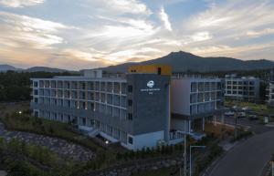 a building with a sign on the side of it at Grand Mer Hotel Seogwipo Ocean in Seogwipo