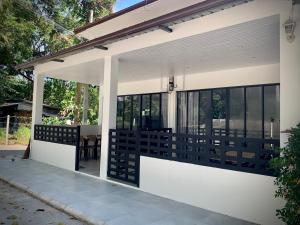 a screened in porch of a house with black and white at Island House Rentals 26 in Ko Samed