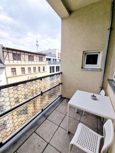 a balcony with a table and chairs on a building at Luxury apartament in the heart of Berlin 45 in Berlin