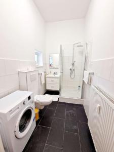 a white bathroom with a washing machine and a toilet at Luxury apartament in the heart of Berlin 45 in Berlin