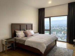 a bedroom with a large bed with a large window at Altair Colombo - View, Location, Ultra Luxury! in Colombo