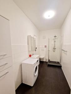 a bathroom with a toilet and a sink and a shower at Cozy apartment in the heart of Berlin 43 in Berlin