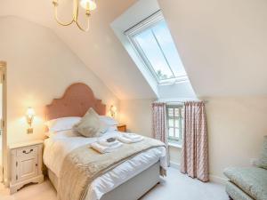 a bedroom with a bed and a large window at Halton Lodge in Spilsby