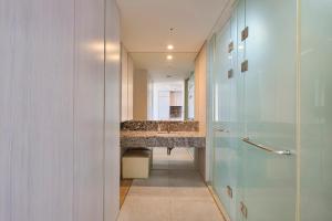 a bathroom with a long hallway with a sink at The Island Blue Hotel in Seogwipo