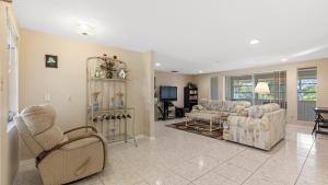 a living room with two couches and a tv at Cozy Family Friendly Home near Mineral Springs in North Port