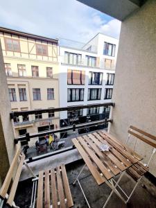 a balcony with two wooden benches and a building at charming apartment in the center of Berlin 34 in Berlin