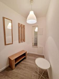 a room with a table and a stool and a mirror at charming apartment in the center of Berlin 34 in Berlin