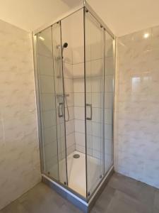 a shower stall with a glass door in a room at * L'appartement centre de Provins * ZEN LOC 4 in Provins