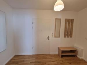 an empty room with a door and a wooden table at Cozy apartment in the center of Berlin 33 in Berlin