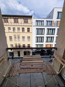 a group of benches in front of a building at Cozy apartment in the center of Berlin 33 in Berlin