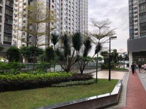 a walkway in a city with trees and buildings at R&F Princess Cove by StayHere - 3BR in Johor Bahru
