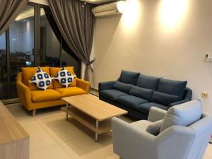 a living room with two couches and a coffee table at R&F Princess Cove by StayHere - 3BR in Johor Bahru