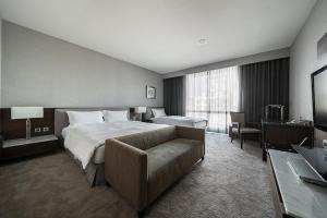 Habitación de hotel con cama y sofá en Taipung Suites en Anping