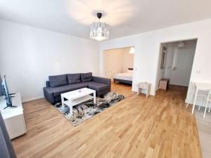 a living room with a couch and a table at Luxurious studio in the center of Berlin 31 in Berlin