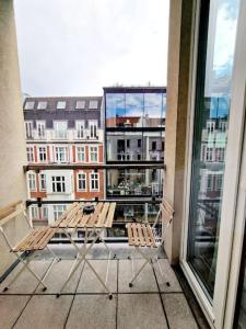 a balcony with two chairs and a view of a city at Luxurious studio in the center of Berlin 31 in Berlin