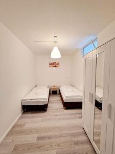 a room with two beds in it with a hallway at Nice apartment in Mitte Berlin 25 in Berlin