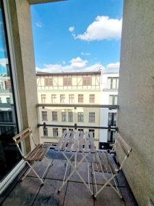 two chairs and a table on a balcony with a building at Nice apartment in Mitte Berlin 25 in Berlin