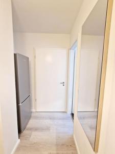 an empty room with a refrigerator and a mirror at Nice apartment in Mitte Berlin 25 in Berlin