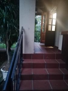 a staircase leading to a building with a door at Sielevreugde in Eersbewoond