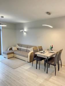 a living room with a couch and a table at Central apartment in Vilnius