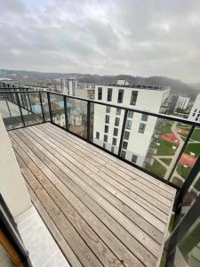 a balcony with a wooden deck on top of a building at Central apartment in Vilnius