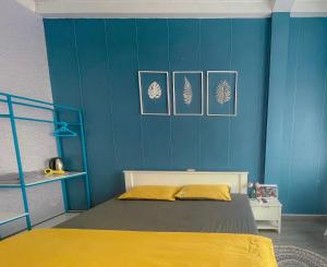 a blue bedroom with a bed and a blue wall at La Casa Homestay - 11B Anh Đào, Bãi Cháy in Ha Long