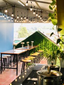 a row of tables and chairs in a restaurant at La Casa Homestay - 11B Anh Đào, Bãi Cháy in Ha Long