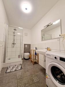 a bathroom with a washing machine and a shower at Luxury flat in the heart of Berlin 14 in Berlin