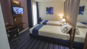 Posteľ alebo postele v izbe v ubytovaní GP Hotel