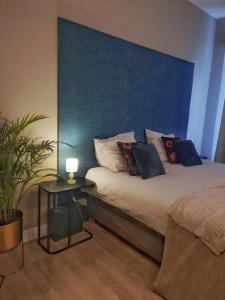 a bedroom with a large bed with a blue headboard at Inn the Green in Zeist