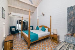 a bedroom with a bed and a chair in a room at Larisa Beach Resort in Morjim