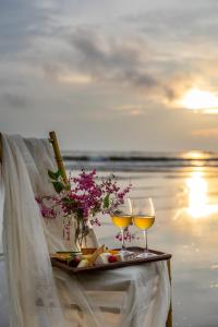 a tray of food and two glasses of wine at Larisa Beach Resort in Morjim