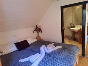 a bedroom with a bed with towels on it at Holiday home Pri Metki - Bohinj in Bohinj