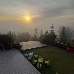 a view of a backyard with a foggy at Phuyafahsai The Resort Khao Kho in Khao Kho
