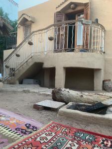 a house with a balcony and a rug in front of it at Mazarita Beach Residence in Sharm El Sheikh