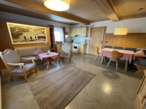 a living room with a table and chairs and a kitchen at Alpengasthof Pichler in Sankt Veit in Defereggen