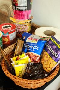 a basket filled with snacks and other foods on a table at Phetrapoolvilla (เภตราพูลวิลล่า) in Surat Thani