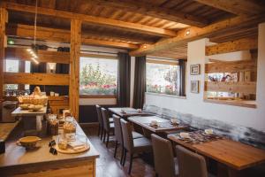 a dining room with wooden tables and chairs at Chalet-Hotel et Spa Le Delta in Le Grand-Bornand