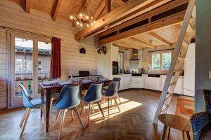 a kitchen and dining room with a table and chairs at Chalet du Bourg in La Tzoumaz