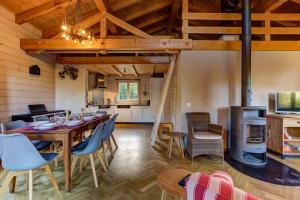 a kitchen and a dining room with a table and chairs at Chalet du Bourg in La Tzoumaz