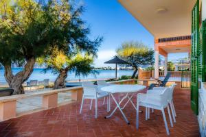 d'une terrasse avec une table et des chaises et une vue sur l'eau. dans l'établissement Sa Marina, à Alcúdia