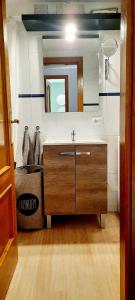 a bathroom with a sink and a mirror at Casa Pereza in Trevélez