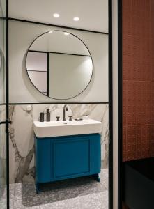 a bathroom with a blue sink and a mirror at The Twentyone in Athens