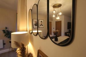 a mirror on a wall with a bed in a room at Alba - 2 Bedroom Luxury Apartment by Mint Stays in Bristol