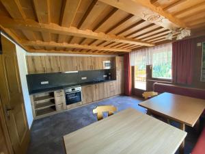 a room with a table and a kitchen with a tv at Ferienhaus Gandle in Kappl