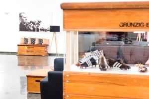 a living room with furniture and figurines on a table at Hotel Akazienhaus in Herzogenaurach