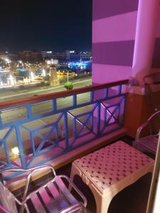 a balcony with a bench and a view of a city at Home Vacation in Porto Sharm in Sharm El Sheikh