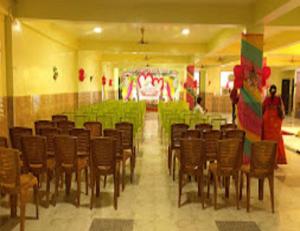 a large room with a bunch of tables and chairs at Hotel Glory Grand, Rajgir in Rājgīr