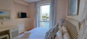 ein Schlafzimmer mit einem Bett und einem großen Fenster in der Unterkunft V&A Waterfront Marina Family Apartment 101 Altmore in Kapstadt