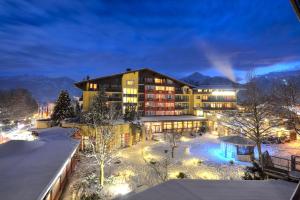 a hotel in the snow at night at Hotel Latini in Zell am See